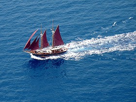 Red-sailed ship in Aegean sea
